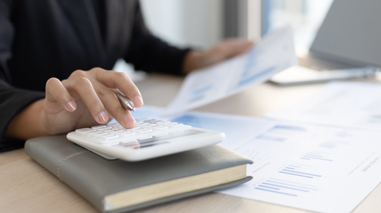 accounting calculator and sheet with data on it